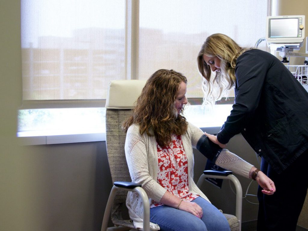 female patient getting blood pressure taken at spine surgery center